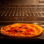 How to reheat pizza the best way possible. This easy-to-follow guide will show you how to reheat your pizza in a microwave or oven, without burning it, and how long it takes.